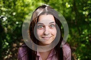 Portrait of surprised smiling cute young woman with emotive wide