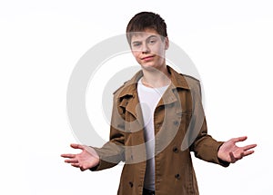 Portrait of surprised teen boy with divorced raised hands isolated on white background.
