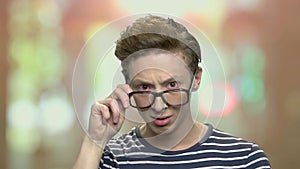 Portrait of surprised teenage boy in eyeglasses.