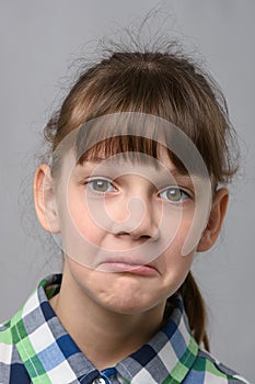 Portrait of a surprised ten year old girl, European appearance, close-up