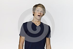 Portrait of surprised and worried male teenager with opened mouth