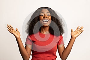 Portrait Of Surprised Young African American Female Raising Hands With Excitement,
