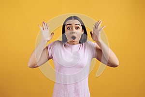 Portrait of surprised young girl in pink tshirt.