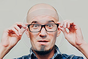 Portrait of Surprised young handsome man wearing glasses