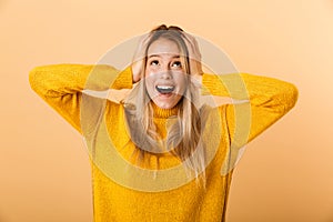 Portrait of a surprised young woman dressed in sweater