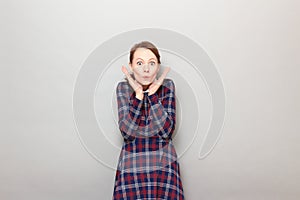 Portrait of surprised young woman shocked by news