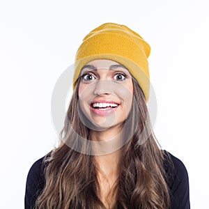 Portrait of surprised young woman wearing yellow beanie hat