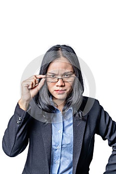 Portrait of a suspicious arrogant young businesswoman looking over her glasses. Confident Asian female business specialist with co