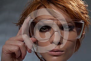 Portrait of suspicious woman in scientist glasses