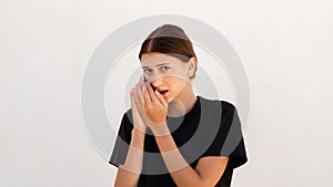 Portrait of suspicious young woman talking on mobile phone