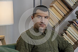 Portrait of a swarthy man 30-35 years old on the background of a home interior.