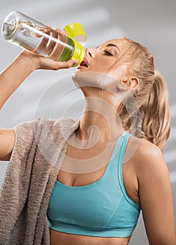 Portrait of sweaty blonde woman take a break after intense workout