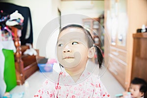 Portrait of Sweet Asian liltle child with look askance face