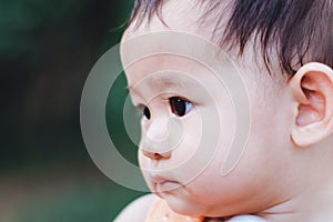 Portrait of sweet Asian litlle child smiling with mommy carry