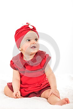 Portrait of sweet baby girl dressed in red having fun