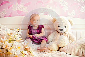 Portrait of a sweet baby girl with her bear