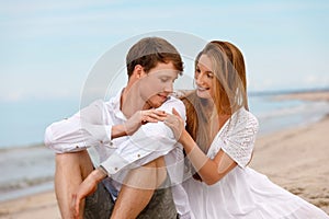 Portrait of a sweet couple of young people resting on the beach