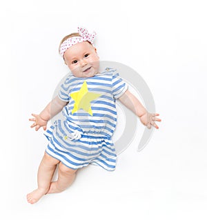 Portrait of a sweet infant baby girl wearing a pink dress and headband bow, isolated on white in studio