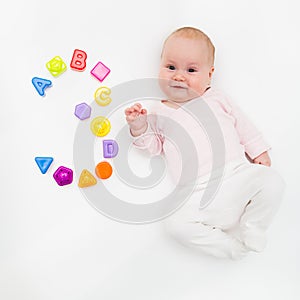 Portrait of a sweet infant baby girl wearing a red dress and bonnet, isolated on white in studio with number tree from
