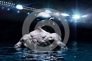 Portrait of a swimmer on the background of a sports arena. The concept of swimming and water games. Back view