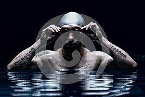 Portrait of a swimmer. The concept of swimming and water games. Front view