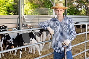 Portrait t worker standing in the yard of a livestock farm