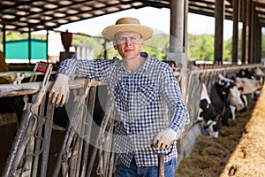 Portrait t worker standing in the yard of a livestock farm