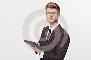 Portrait, tablet and glasses with a business man in studio isolated on a white background for management. Corporate