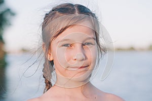 portrait of tanned Portrait of a tanned little girl in a sundress by the sea