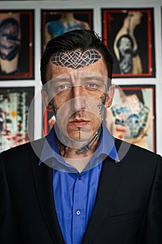 Portrait of tattoo artist in black jacked and shirt
