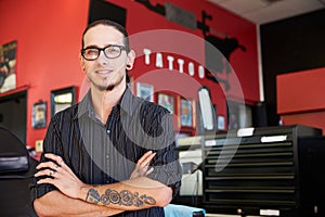 Portrait Of Tattoo Artist Standing Inside Parlor