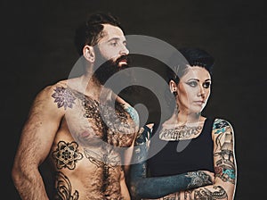 Portrait of tattooed man and woman at photo studio