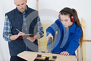 Portrait teacher grading apprentice