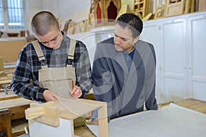 portrait teacher guiding apprentice