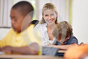 Portrait of teacher, kid or writing in classroom for learning, education and helping for development. Happy woman