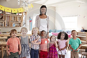 Portrait Of Teacher With Pupils In Montessori School Classroom