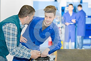 portrait teacher talking to apprentice