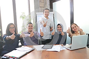 Portrait team of asians business inside indoors room office with windows and plant