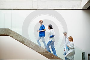 Portrait of team of doctors standing on stairs. Healthcare team with doctors, nurses, professionals in medical uniforms