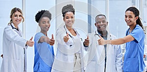 Portrait, team of doctors and thumbs up for teamwork, support and hospital services mission. Medical nurses, people or