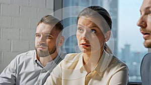 Portrait of a team of professionals communicating in a meeting while sitting at desk