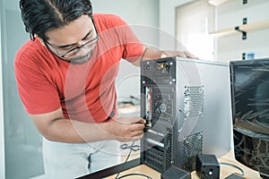 Portrait of technician install a new hardware a part of personal computer