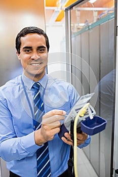 Portrait of technician using digital cable analyzer