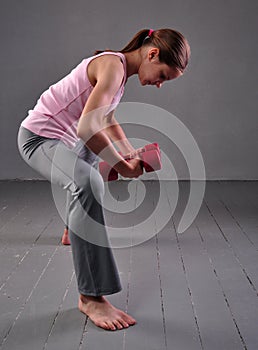 Portrait of teen age sportive girl exercising with dumbbells