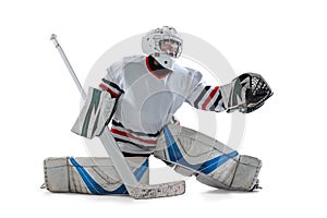 Portrait of teen boy, goalkeeper, hockey player taining isolated over white studio background