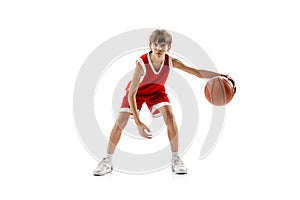 Portrait of teen boy, motivated sportsman training, playing basketball isolated over white studio background