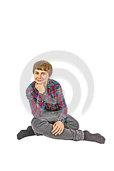 Portrait of teen boy sitting on the floor in studio