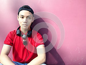 Portrait of a teen with a cap on and ear phones
