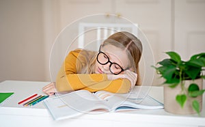 Portrait Of Teen Girl Sleeping At Desk, Tired After Doing School Homework