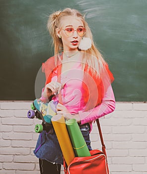 Portrait of a teen female student, charming teenager younf school girl with wearing funny eyeglasses and backpack.